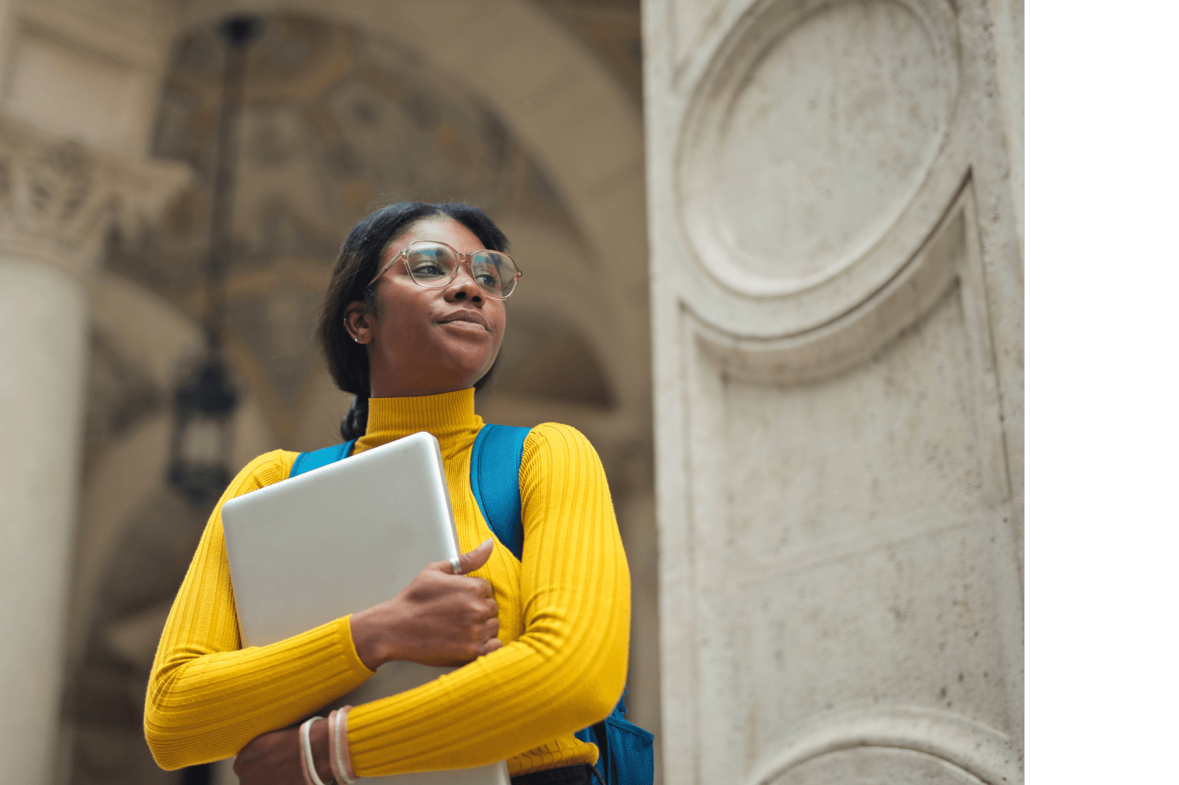 Young woman with laptop outside school